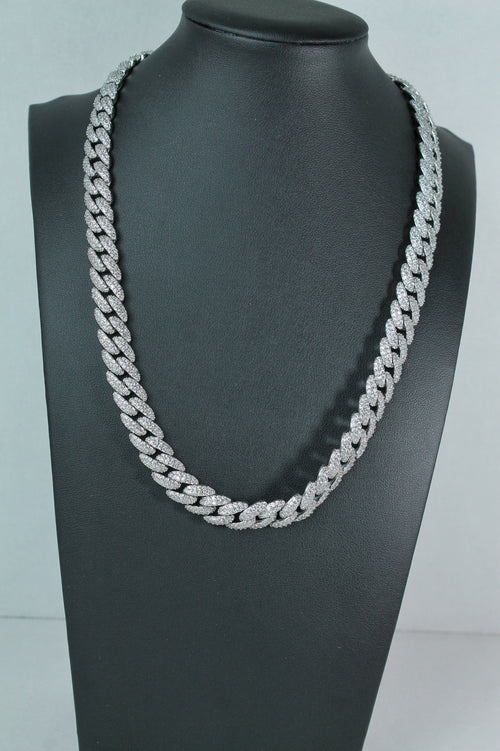A thick silver Cuban link chain necklace displayed on a black mannequin bust against a light gray background.