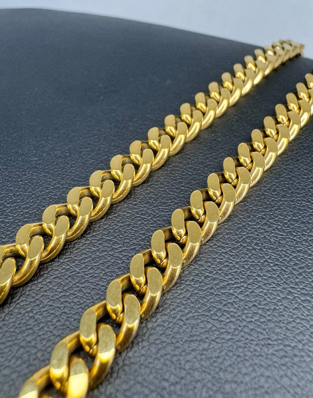 Gold chain on a textured black surface