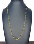 A gold paperclip chain necklace displayed on a matte black jewelry bust against a white background.