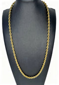 Gold rope chain necklace on a black mannequin