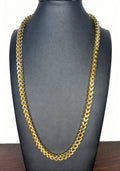A thick gold Franco link chain necklace displayed on a black jewelry bust against a white background.