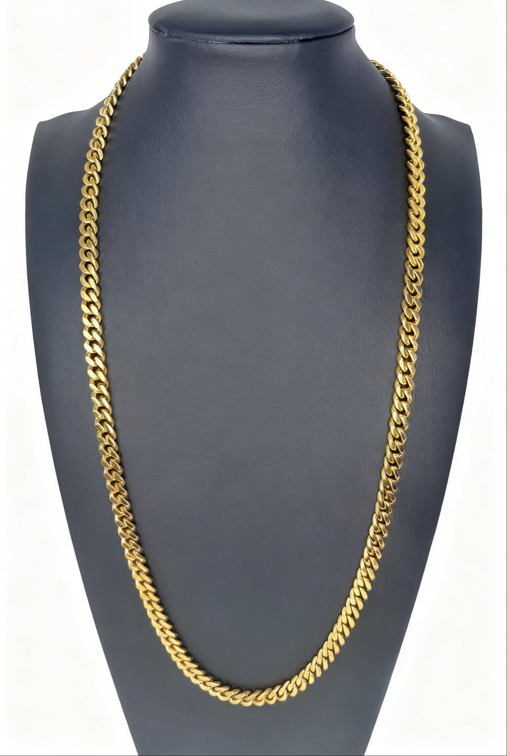 Gold chain necklace on a gray mannequin bust