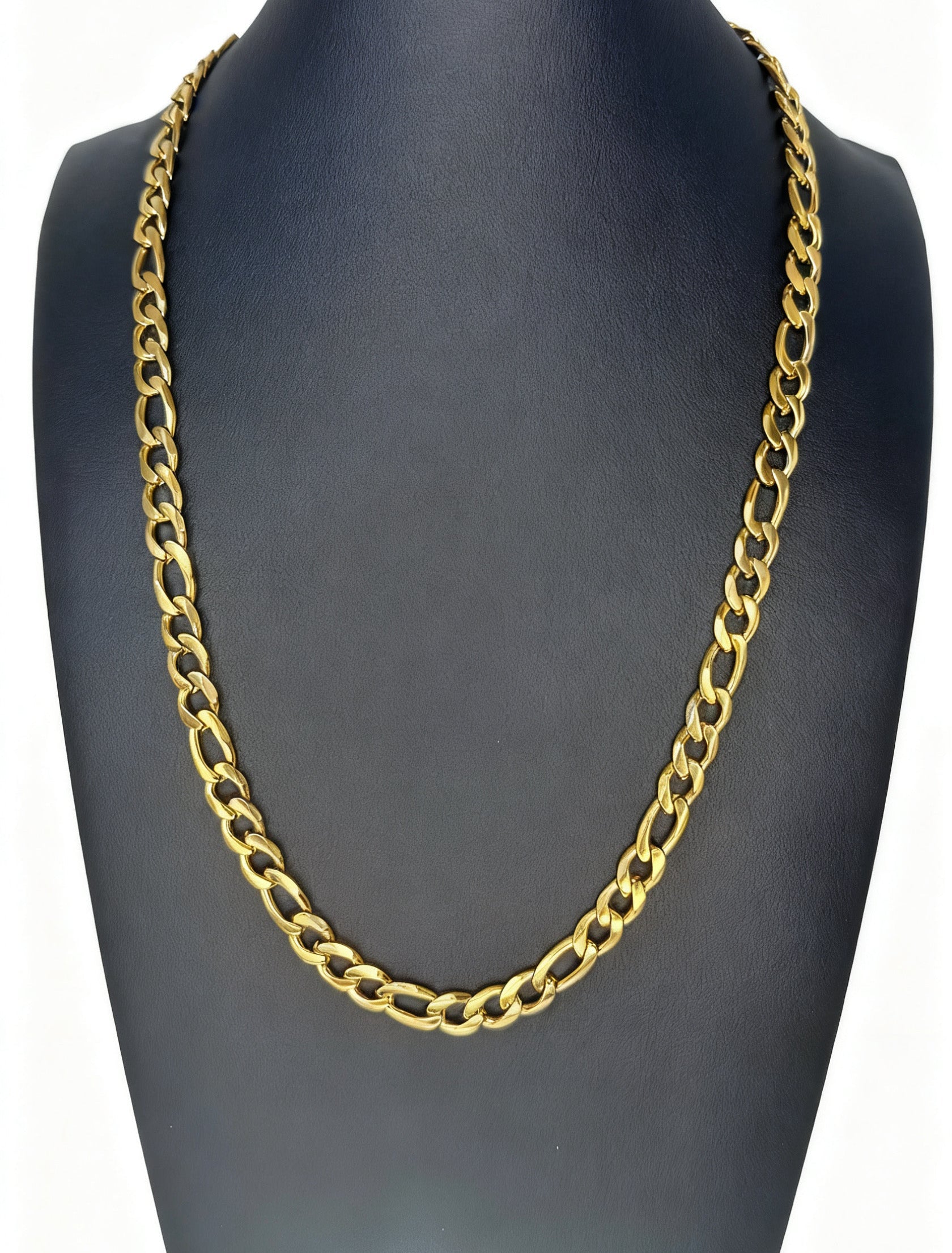 Gold chain necklace on a black mannequin bust