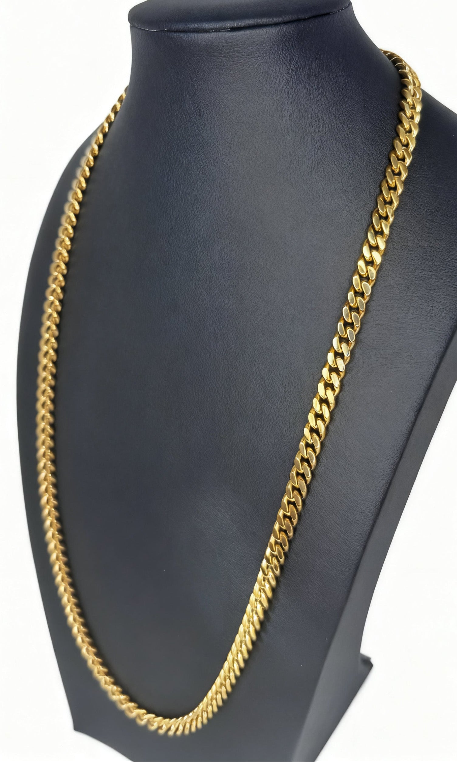 Gold chain necklace on a black mannequin bust