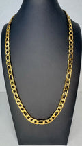 A chunky gold Figaro link chain necklace displayed on a black mannequin bust against a light gray background.