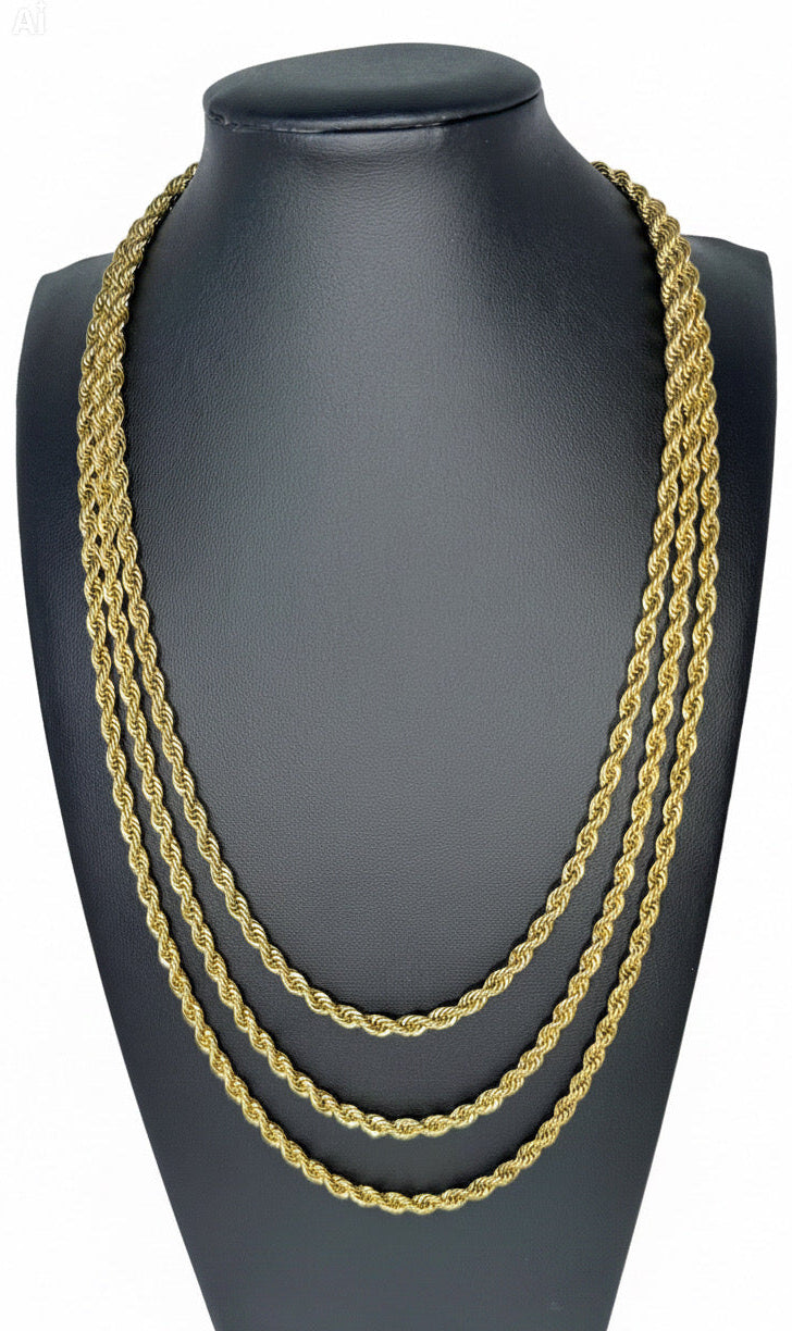 Gold chain necklace stack on a black mannequin bust