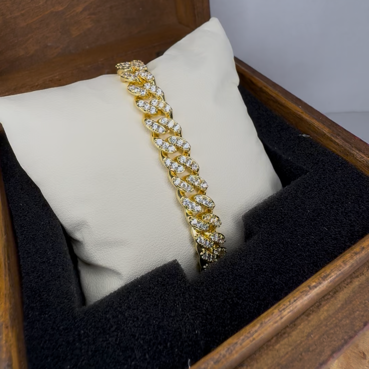 Gold bracelet in a jewelry box with a white pillow