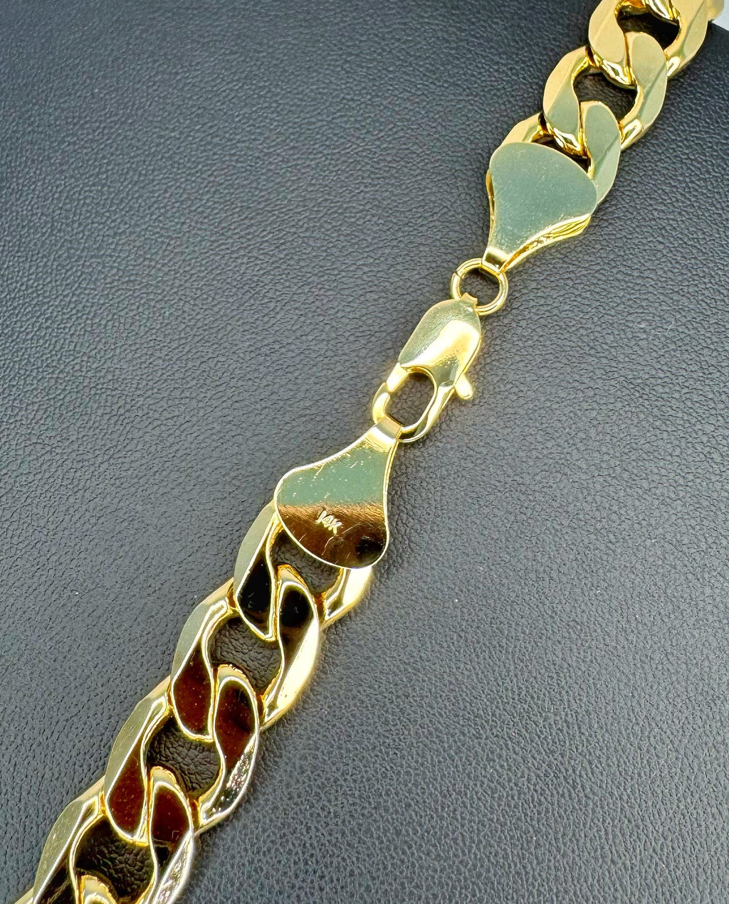 Gold chain bracelet on a dark gray background