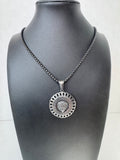 Silver chain with a decorative lion pendant on a mannequin against a white background