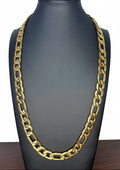 A chunky gold Figaro link chain necklace displayed on a black mannequin bust against a white background.
