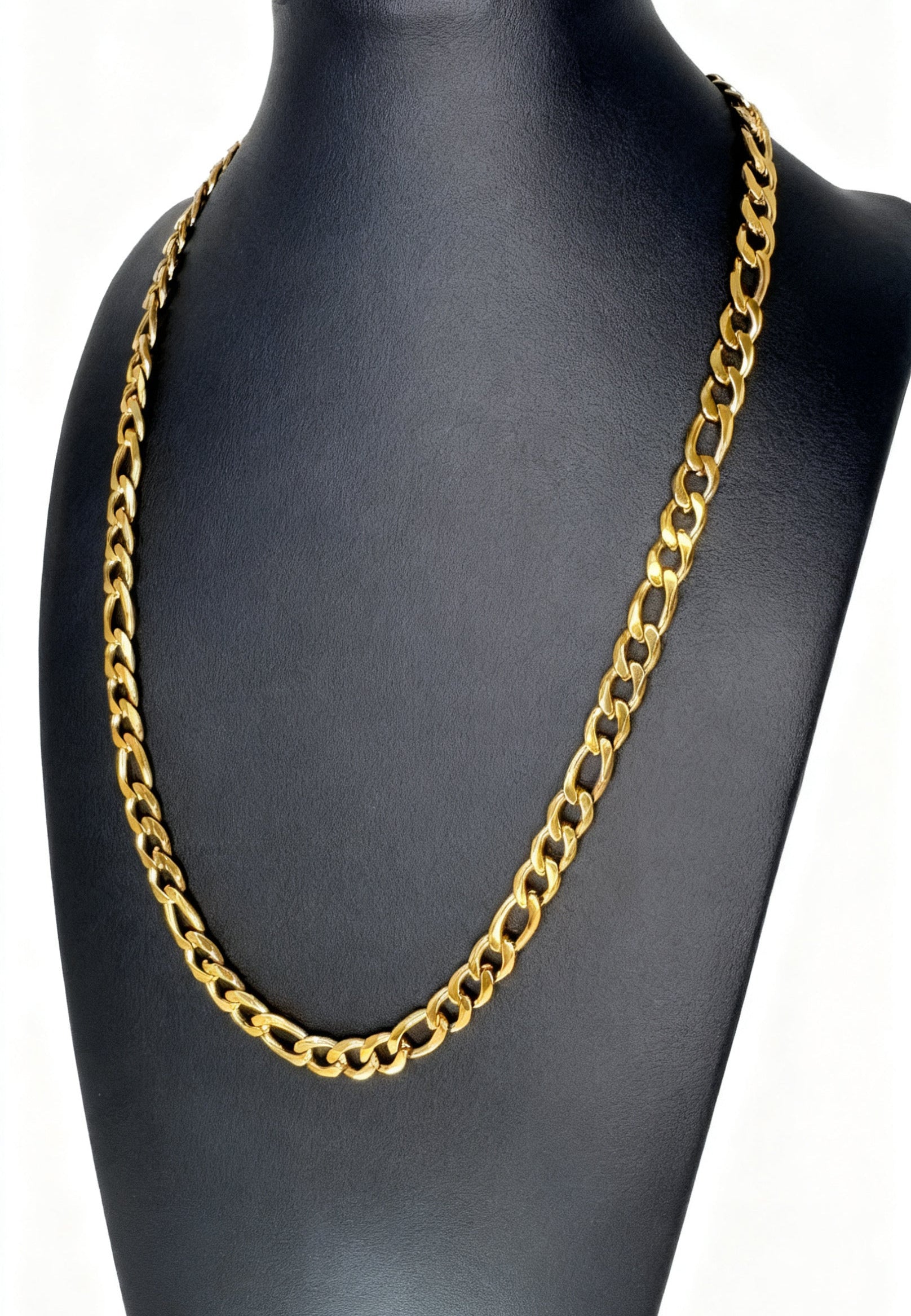 Gold chain necklace on a black mannequin bust