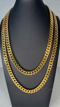Two thick gold Curb link chain necklaces displayed on a black mannequin bust against a light gray background.