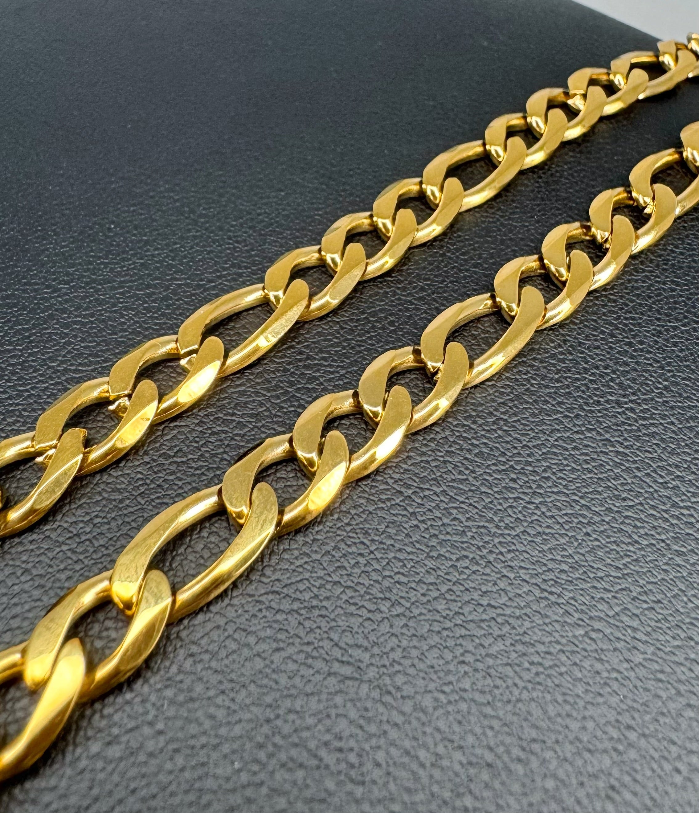 Gold chain on a dark textured surface